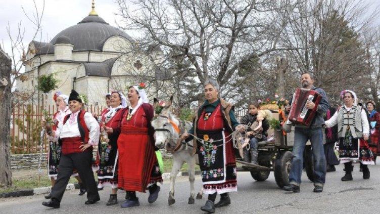 Празникът започва с хоро на селския площад, под съпровода на песни, а бабите от селото се отправят към дома на акушерката. Снимка: Булфото, архив