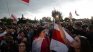 Лукашенко празнува рождения си ден облечен в бронежилетка и с автомат