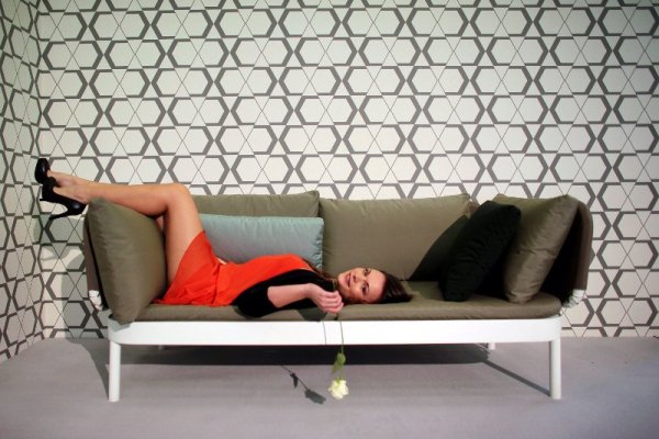 Манекенка промотира диван по време на изложение за мебели в германския град Кьолн. Снимка: БТА