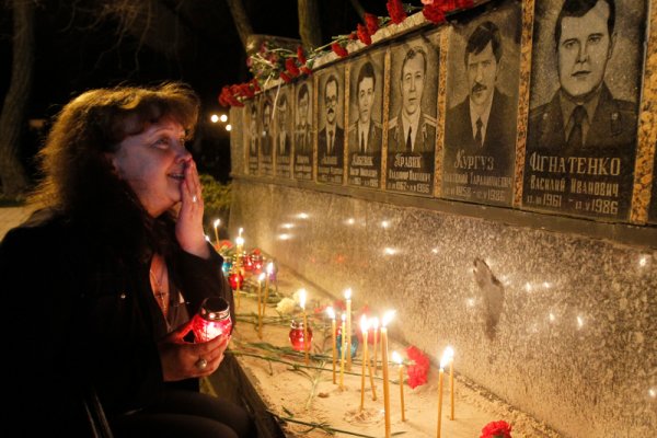Жена плаче пред паметника на загиналите работници и пожарникари в борбата с бедствието в украинския град Славутич. Снимка: Reuters