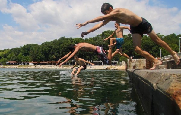 Деца се разхлаждат със скокове в района на първа буна във Варна. Снимка: Impact Press Group
