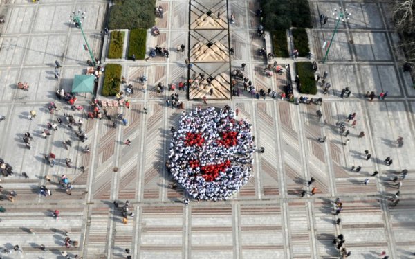 Деца, облечени в бели и червени тениски, направиха &quot;жива мартеница-усмивка&quot; на централния площад &quot;Бдинци&quot; във Видин. Снимка: БТА